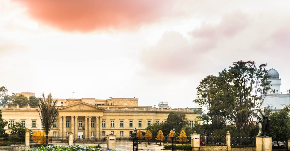 Beautiful view of Casa de Nariño, Bogotá, with a colorful sky, showcasing neoclassical architecture.